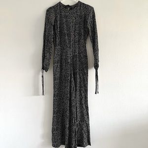 Reformation petites missy jumpsuit in 0P. Black jumpsuit with white flowers.